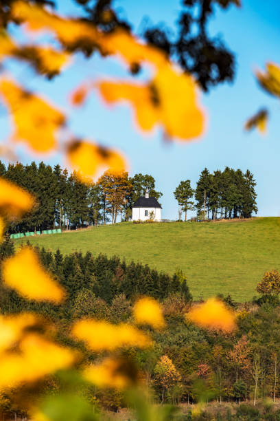 istock small chapel and colorful trees with leaves in fall at low mountain range sauerland, germany 1066185696