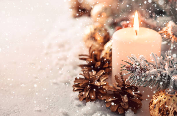 istock Beige snow Christmas composition. Burning candle and fir cones 1066188624