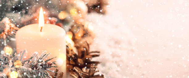 istock Christmas banner. Burning candle and cones on snow background 1066188654