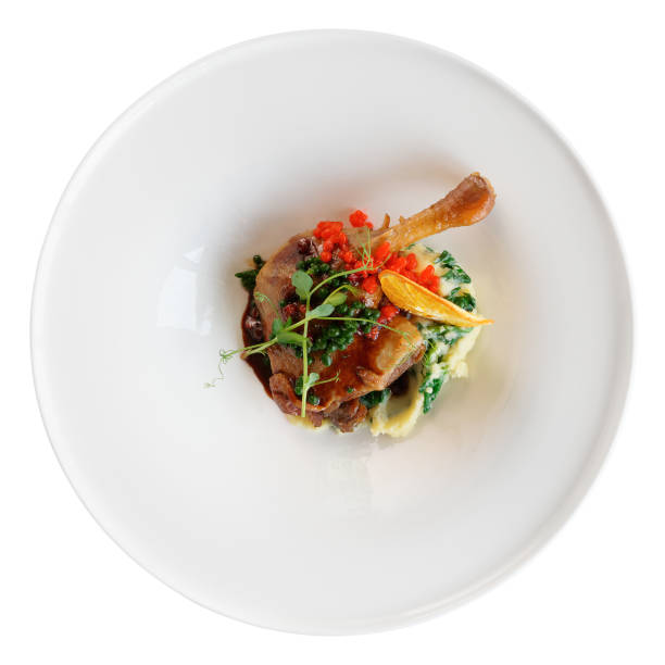 istock Fried duck leg in round porcelain plate isolated on white 1066189572