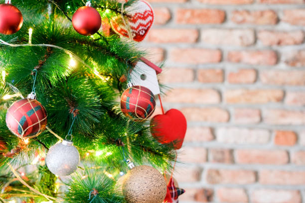 istock Christmas tree with ornaments and blank brick wall 1066191858