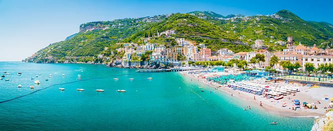 Scenic panoramic view of the beautiful town of Amalfi at famous Amalfi Coast with Gulf of Salerno in summer, Campania, Italy