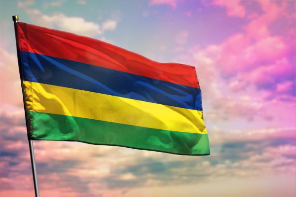 istock Fluttering Mauritius flag on colorful cloudy sky background. Prosperity concept. 1066196834