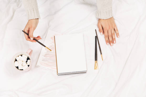 istock Empty blank,coffee,watercolor brush in woman's hands.Top view,flat lay 1066203782