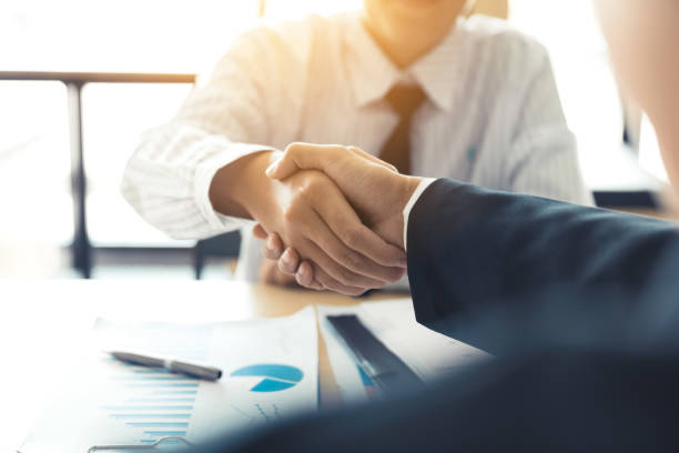 istock Business people accept or confirm project on the proposal and join shaking hands at office. 1066204750