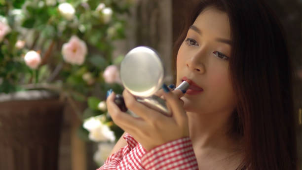 istock Beautiful girl using lipsick and make up her face. 1066204856