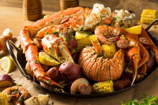Homemade Cajun Seafood Boil Homemade Cajun Seafood Boil with Lobster Crab and Shrimp seafood boil stock pictures, royalty-free photos & images