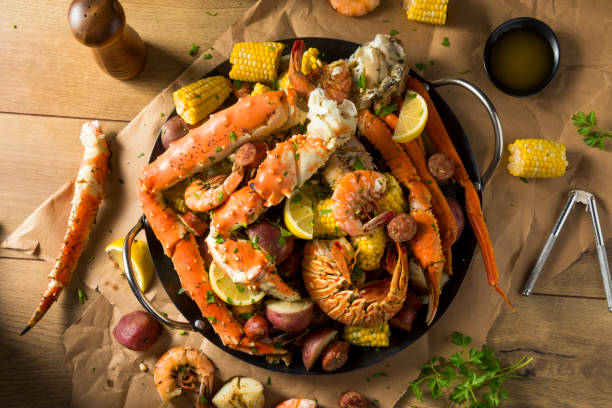 Homemade Cajun Seafood Boil Homemade Cajun Seafood Boil with Lobster Crab and Shrimp crab seafood photos stock pictures, royalty-free photos & images