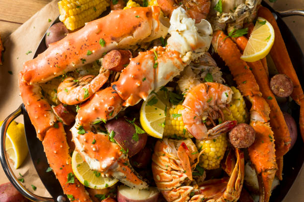 Homemade Cajun Seafood Boil Homemade Cajun Seafood Boil with Lobster Crab and Shrimp crab seafood photos stock pictures, royalty-free photos & images