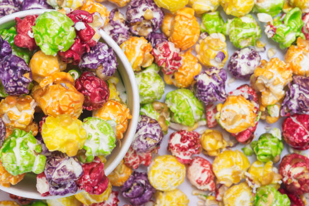 istock background of multicolored popcorn and paper cup, close-up, top view 1066216928