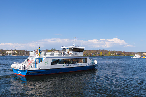 Stockholm, Sweden - May 4, 2016: Small electric powered passenger ferry goes near the coast of Stockholm city