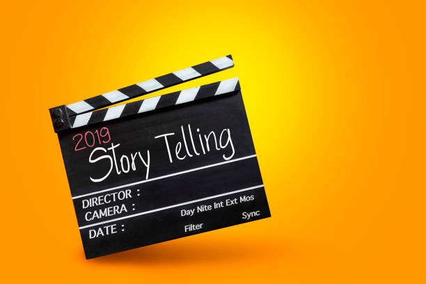 istock 2019 story telling ,text title on movie Clapper board on orange colour backgrounds 1066227328