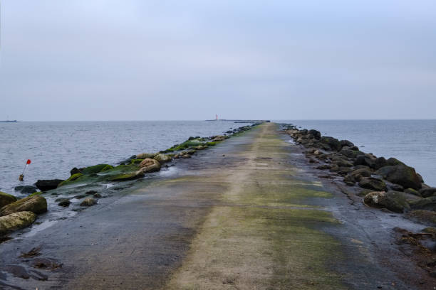 istock breakwater in sea with old metal railing port dock 1066239310