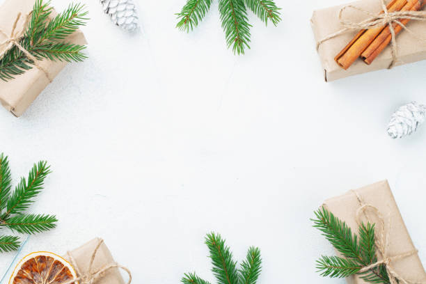 istock Christmas composition. Christmas gift, pine cones, fir branches on stone white background. Flat lay, top view, copy space 1066241950