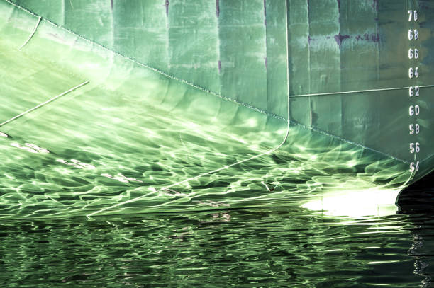 the stern of a ship, with draft markings, and its reflection on the water's surface - 65 70 age imagens e fotografias de stock