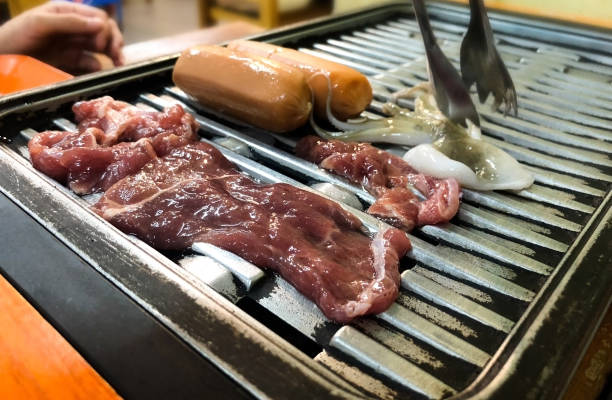 istock Seafood on electric grill include cockle and squid in chabu store 1066242116