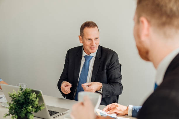 istock Smiling businessman talking to coworker 1066248392