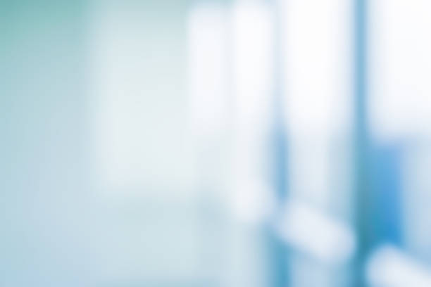 abstract blurred interior of corridor clinic background in blue color , blurry image for presentation ,banner ,ads design concept - reflective glass imagens e fotografias de stock
