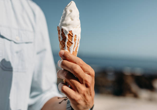 istock Close up of a man holding a cone ice cream 1066249206