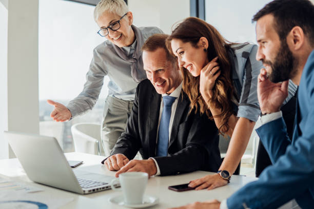istock Happy people looking at laptop 1066249320