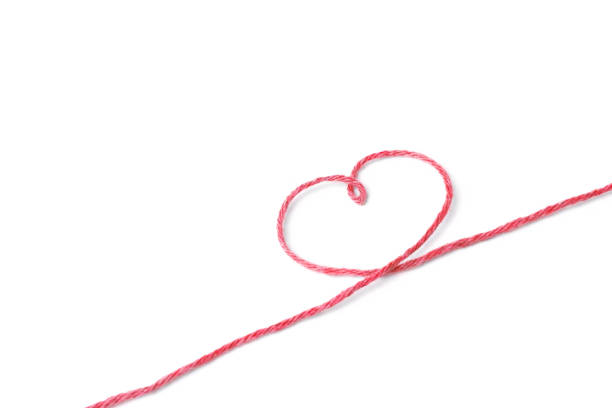 istock Red thread and heart isolated on white background 1066251546