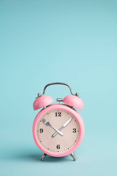 istock Alarm clock. Fork and knife instead of clock hands 1066251550