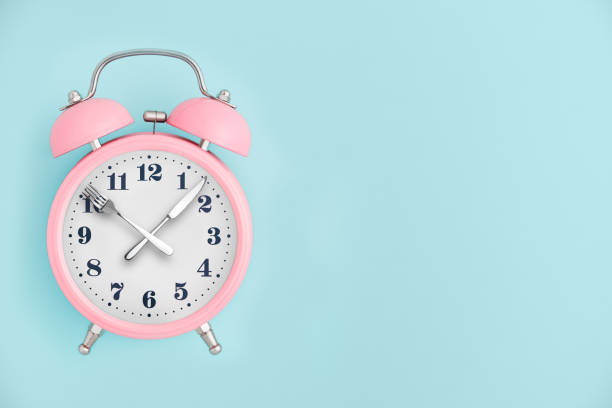 istock Alarm clock. Fork and knife instead of clock hands 1066251552