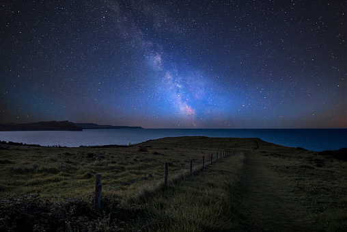 Stunning vibrant Milky Way composite image over landscape of Mupe Bay on Jurassic Coast in England