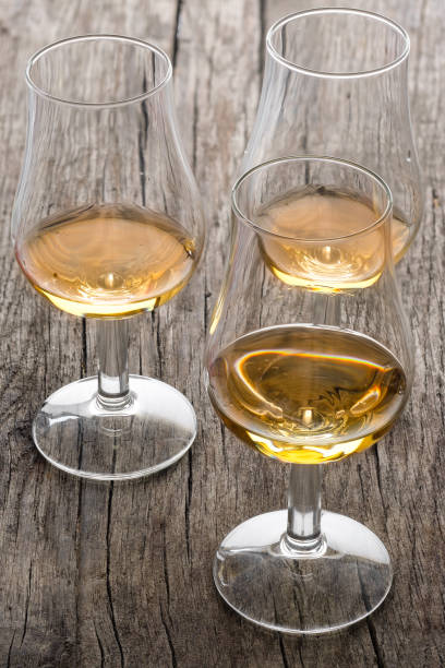 istock Glasses with scottish single malt whisky on wood in vertical format 1066257798