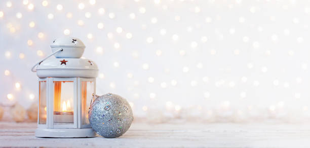 istock White lantern with candle and silver ball - Christmas decoration. Banner. 1066259132