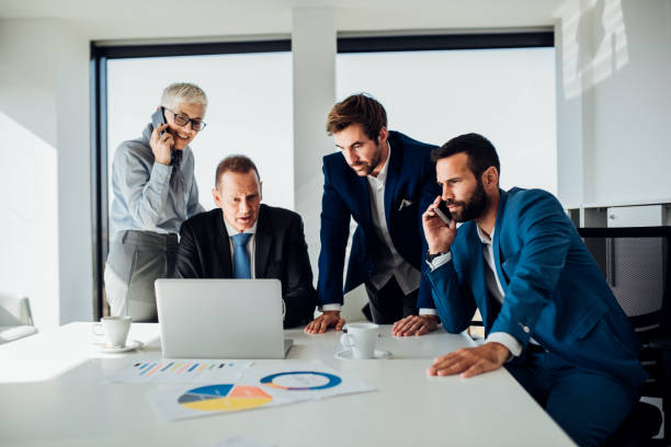 istock Business people using laptop and mobile phone 1066259134