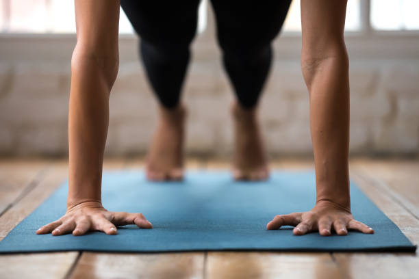 istock Young woman practicing yoga, doing Push ups or press ups 1066259632