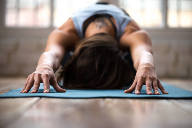 istock Young sporty woman practicing yoga, doing Child exercise, close up 1066259634