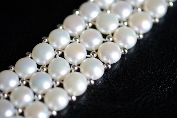 istock White pearl necklace on a dark background close up 1066260286