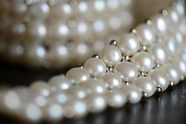 istock White pearl necklace on a dark background close up 1066260306