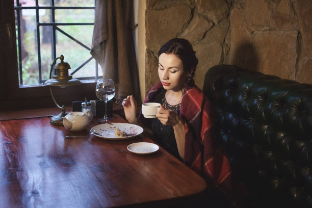 istock Woman drinking tea in a cafe in the evening. 1066261946