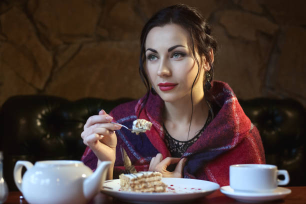 istock Woman in a cafe eats cakes. 1066261982