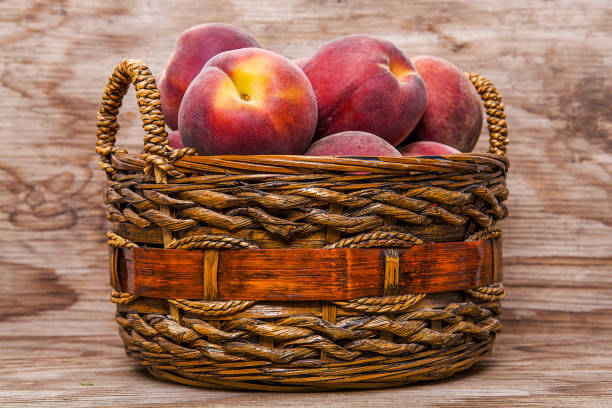Peach isolated on wooden background.