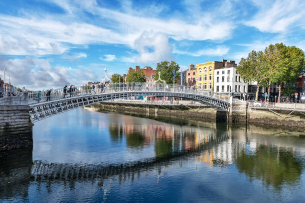 Ha'penny Bridge (also known as Liffey Bridge) across the River Liffey, Dublin, Ireland. Distant people.