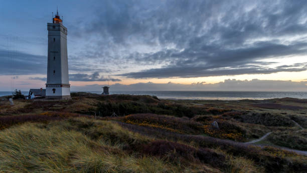 Sunset Light house and bunker at a beach in Denmark This picture was taken in November 2018 in Billund Denmark. billund stock pictures, royalty-free photos & images