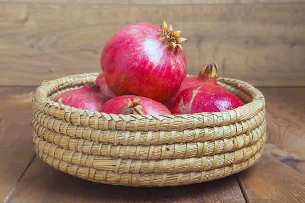 istock Pomegranate isolated on wooden background. 1066266480