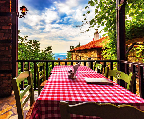 table on terrace of restaurant, checkered tablecloth, surrounded by beautiful nature