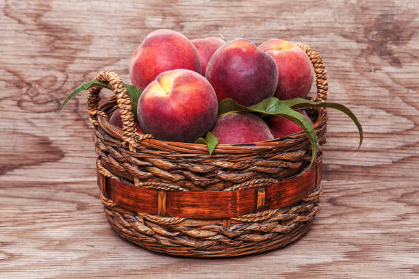 Peach isolated on wooden background.