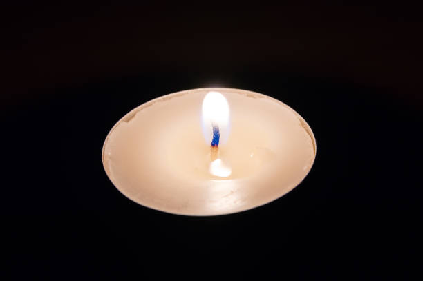 istock Flame of white candle at night. 1066278338