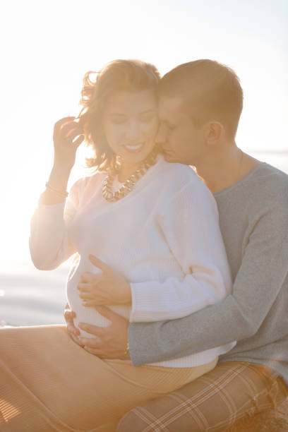 happy couple preparing for having a child - couple human pregnancy sunset walking imagens e fotografias de stock