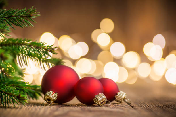 istock Three Christmas Balls on rustic wood and sparkles defocused lights on the backgorund 1066284866