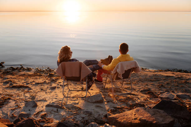 istock Romantic couple sitting on chairs on the beach 1066286108