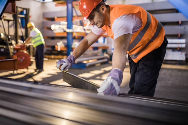 istock Manual worker using tape measure while working in steel mill. 1066286736