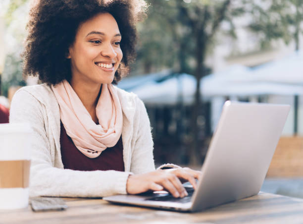 istock Young afro-american woman typing on laptop 1066286982