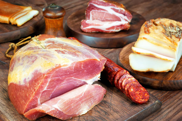 istock Smoked ham and bacon on wooden table 1066288510